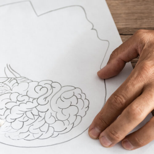 man with Alzheimer's disease drawing human head and brain
