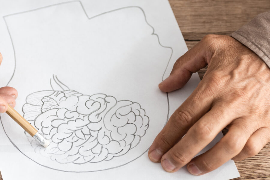 man with Alzheimer's disease drawing human head and brain